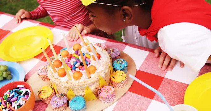 Kids in various costumes celebrating birthday in the park 4k