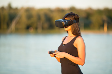 beautiful woman  with virtual reality in outdoor park.