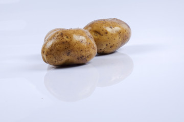 Fresh raw potato on white background.