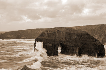 sepia virgin rocks with storm waves