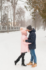 Young couple man and woman in winter Park