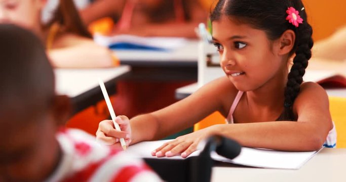 Schoolgirl doing her homework in classroom at school 4k