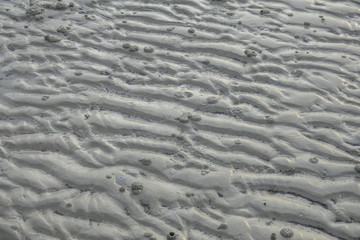 Sand pattern of a beach as background.