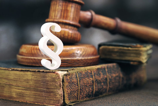 Law gavel on old brown leather book 