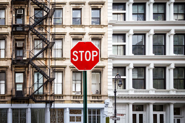 Stop Sign in front of Old Historic Buildings in New York City NYC