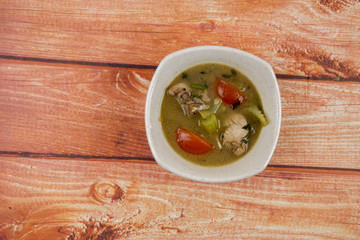 Chicken soup on wooden table. Top View.