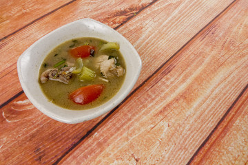 Chicken soup on wooden table. Top View.