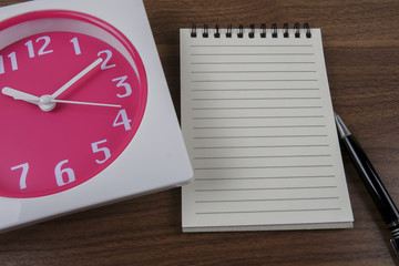 Fototapeta na wymiar time management conceptual,book,pen and clock on wood
