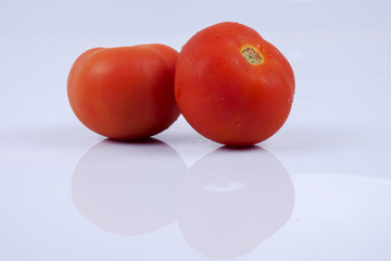 Ripe fresh tomato isolated on white.