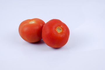 Ripe fresh tomato isolated on white.