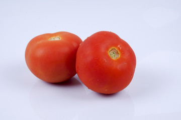 Ripe fresh tomato isolated on white.