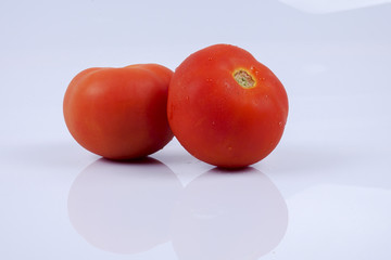 Ripe fresh tomato isolated on white.