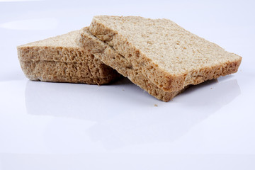Loaf of wholemeal bread on white background