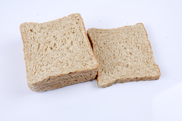 Loaf of wholemeal bread on white background