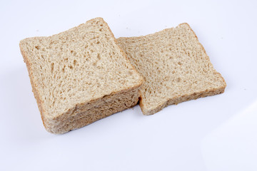 Loaf of wholemeal bread on white background