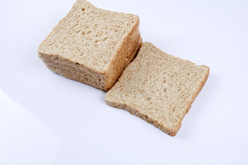 Loaf of wholemeal bread on white background