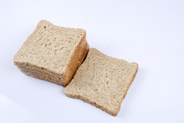 Loaf of wholemeal bread on white background