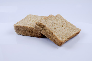Loaf of wholemeal bread on white background