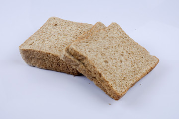 Loaf of wholemeal bread on white background
