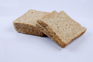 Loaf of wholemeal bread on white background