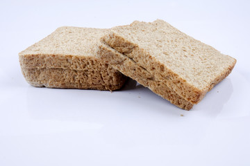 Loaf of wholemeal bread on white background