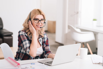 Good looking professional woman wearing headphones