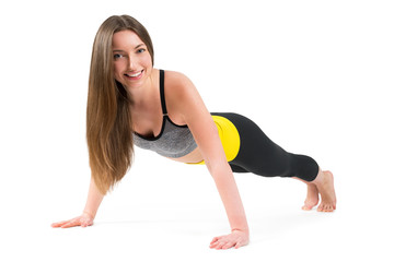 Fototapeta premium Portrait of a beautiful sports young woman on a white background
