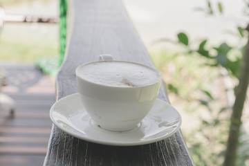 Selective focus white cup of Coffee, latte on the wooden table.