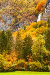 Fototapeta premium Periodic incredible waterfall in the autumn mountains