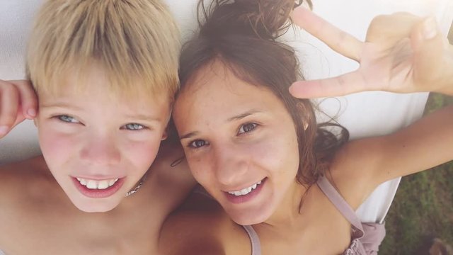 Happy pretty mother and her son have a rest in a garden in hammock in slowmotion. 1920x1080