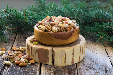 Christmas arrangement of pine, cashew, almond, hazelnuts, peanuts, walnuts, tree branches, cones.  background. A mix  nuts.