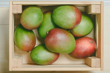 Close-up of mango fruit in wooden box