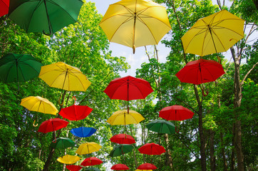 Fototapeta na wymiar RUSSIA, MOSCOW REGION.Colorful umbrellas in the sky. Street decoration in the park