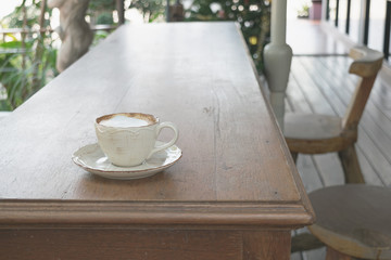 Fototapeta na wymiar Close up white cup of Coffee, latte on the wooden table