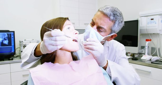 Dentist examining a patient in the examination room