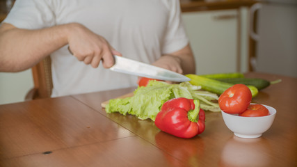 Obraz na płótnie Canvas close up hands cook cut vegetables with a knife