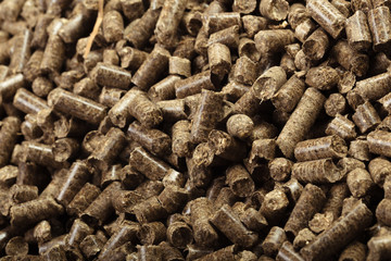 Wood pellets in the background.