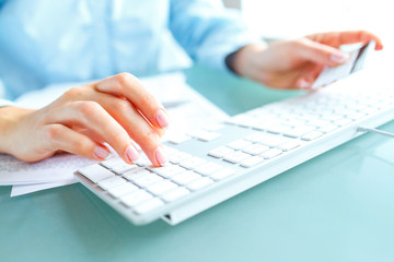 Hands using computer and credit card