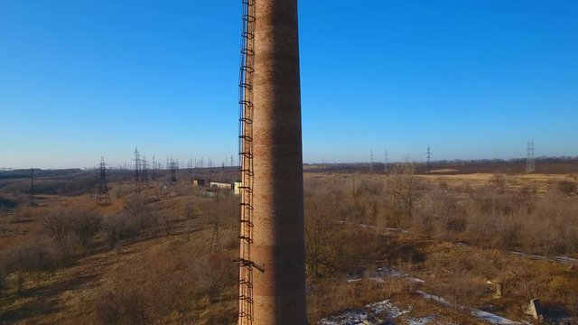 Factory chimney. Old crumbling pipe made of bricks. Steadicam shot.