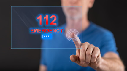 Man touching an emergency concept on a touch screen