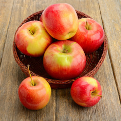 red apples on a wooden surface