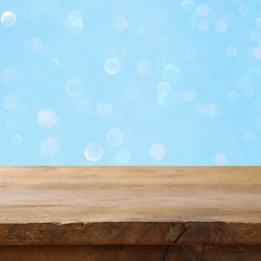 Fototapeta na wymiar Empty table in front of blue glitter lights background