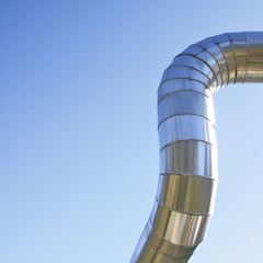 Geothermal power pipe structure against a blue background - image with copy space