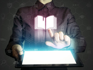 Concept of online: learning ,library, school etc. Person touches to the book icon. She holds tablet...
