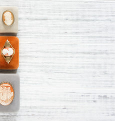 Woman's Jewelry. Vintage jewelry background. Beautiful vintage cameo brooches and jewelry boxes on...