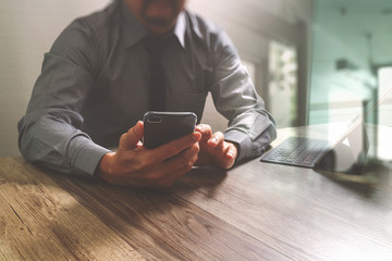 businessman using smart phone and keyboard dock digital tablet.W