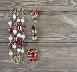 Woman's Jewelry. Vintage jewelry background. Beautiful bright rhinestone brooch and necklace on...