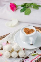 Breakfast in bed on copper tray over bed linens.