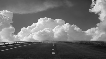 Free highway on a background of beautiful clouds. black and whit - 134505678