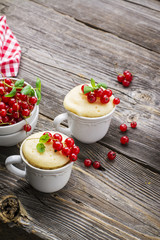Healthy breakfast. Fresh homemade mug cake with berries in a white ceramic bowl   sprig of ripe  on the gray wooden background. selective focus